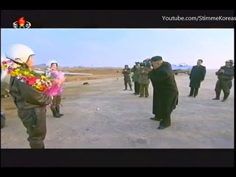 Kim Jong Un taking pictures of female pilots